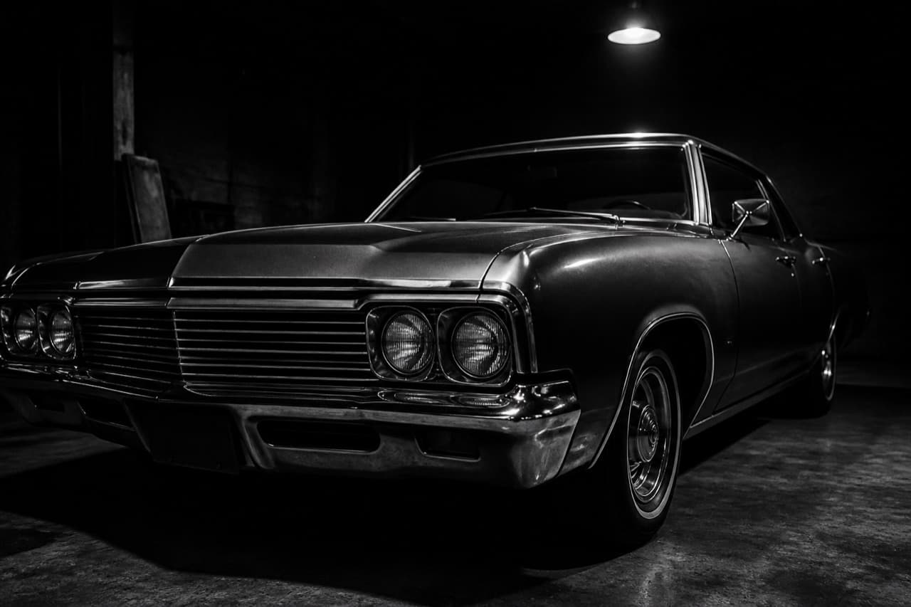 Classic sedan under a single garage light