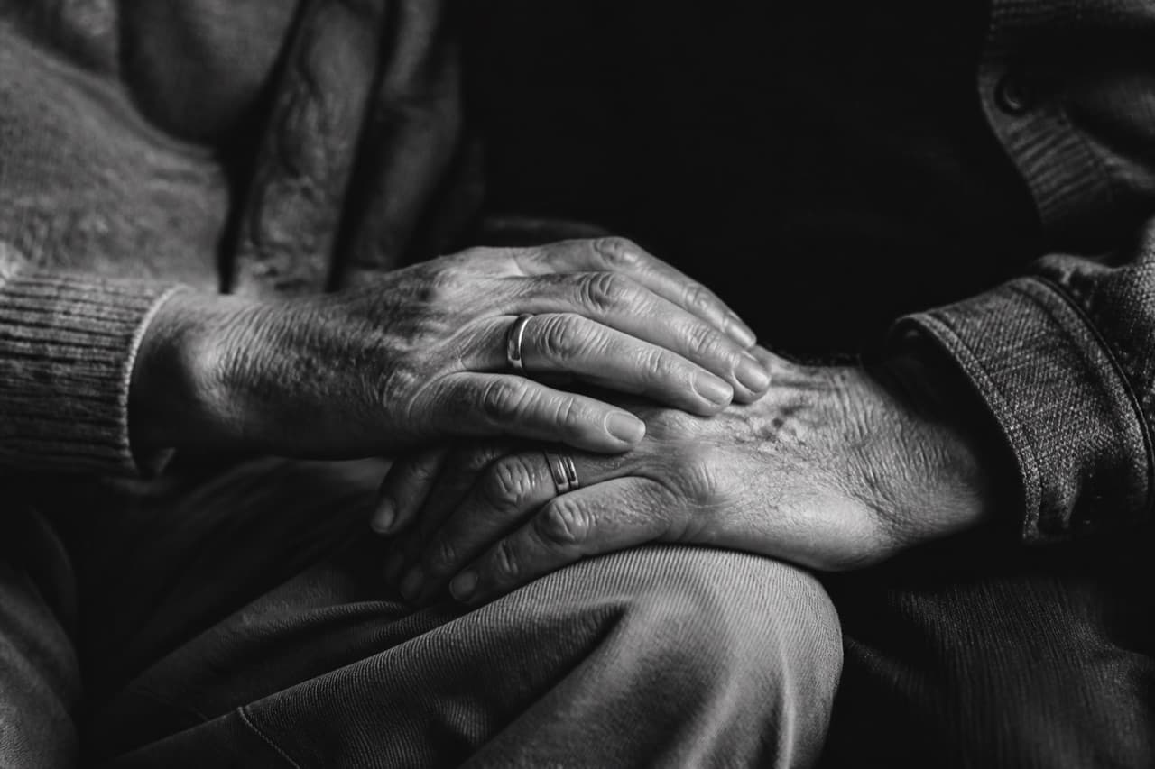 Elderly couple holding hands