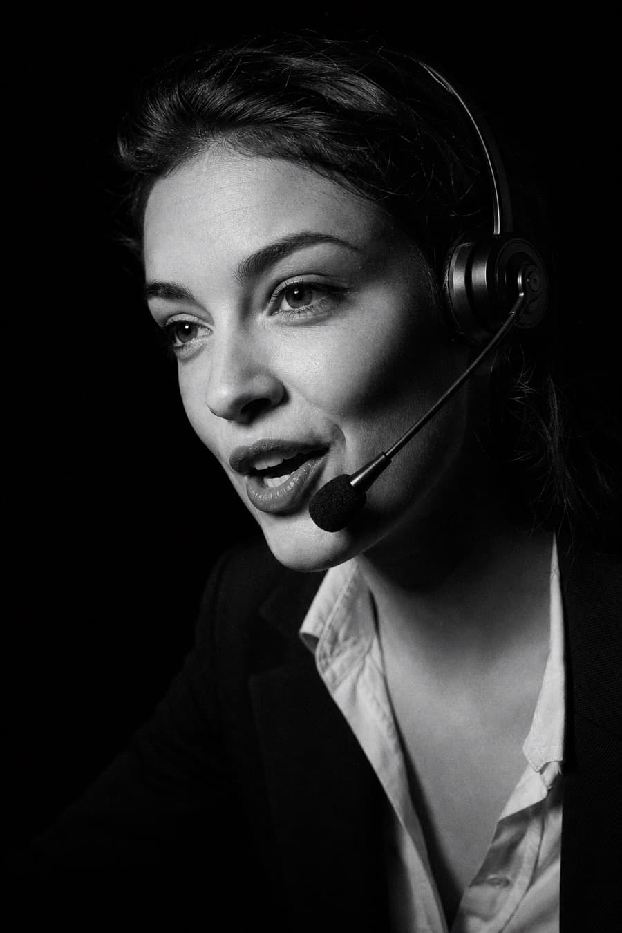 Agent with headset mid-sentence, opening a call